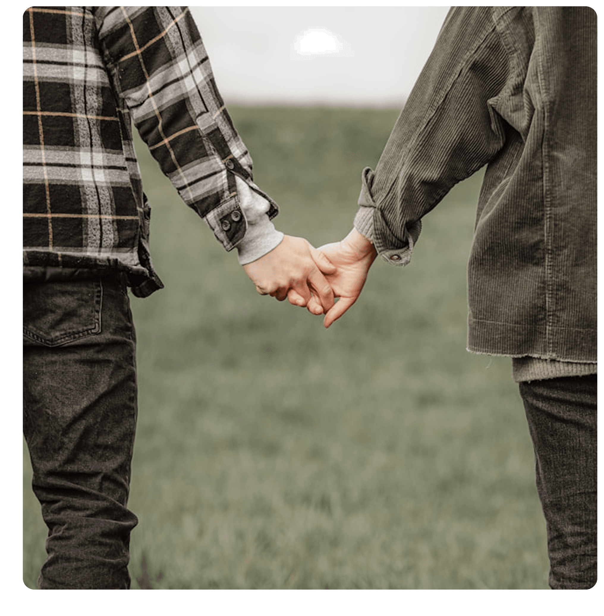 Two people holding hands in a field — the kind of connection that grows from shared experience
