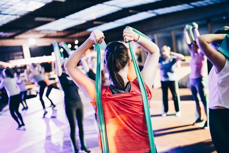 Group fitness class stretching with resistance bands